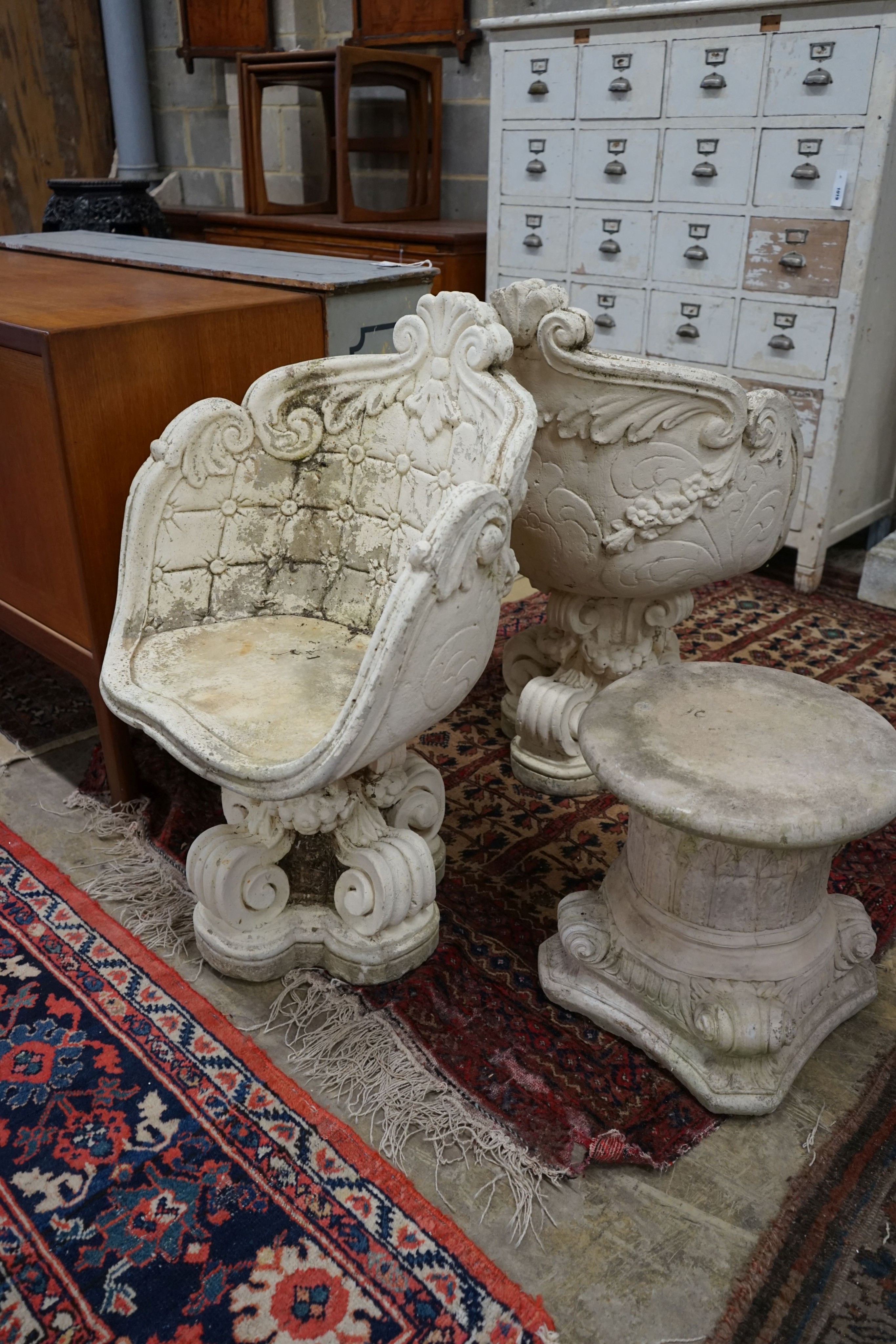 A pair of reconstituted stone tub framed garden chairs, width 55cm, depth 42cm, height 84cm together with a similar low table